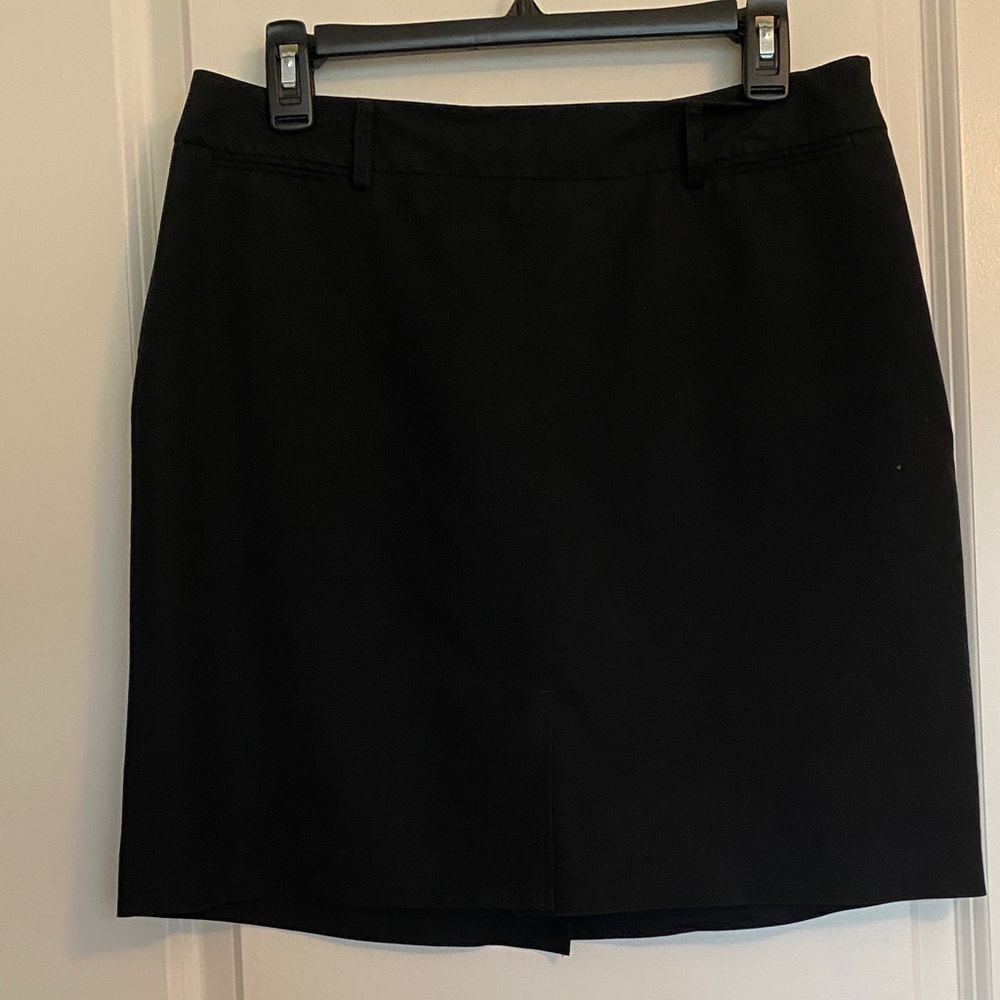 Black Skirt w/front & back slits. Faux pockets. Light weight rayon & polyester.